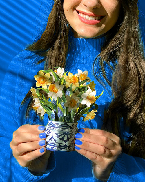 Woman holding Mini English daffodil bouquet