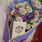 Watch our FreshCut Paper Field of Daisies bloom!, FreshCut Paper's bountiful Daisies and Wildflowers symbolize freshly gathered in the foothills of Colorado are in full bloom with our latest paper bouquet. This charming pop up bouquet symbolizes friendship and new beginnings. Presented in a classic embossed vase, this bouquet is sure to bring a smile. Our pop up 3D greeting cards are perfect for any occasion.