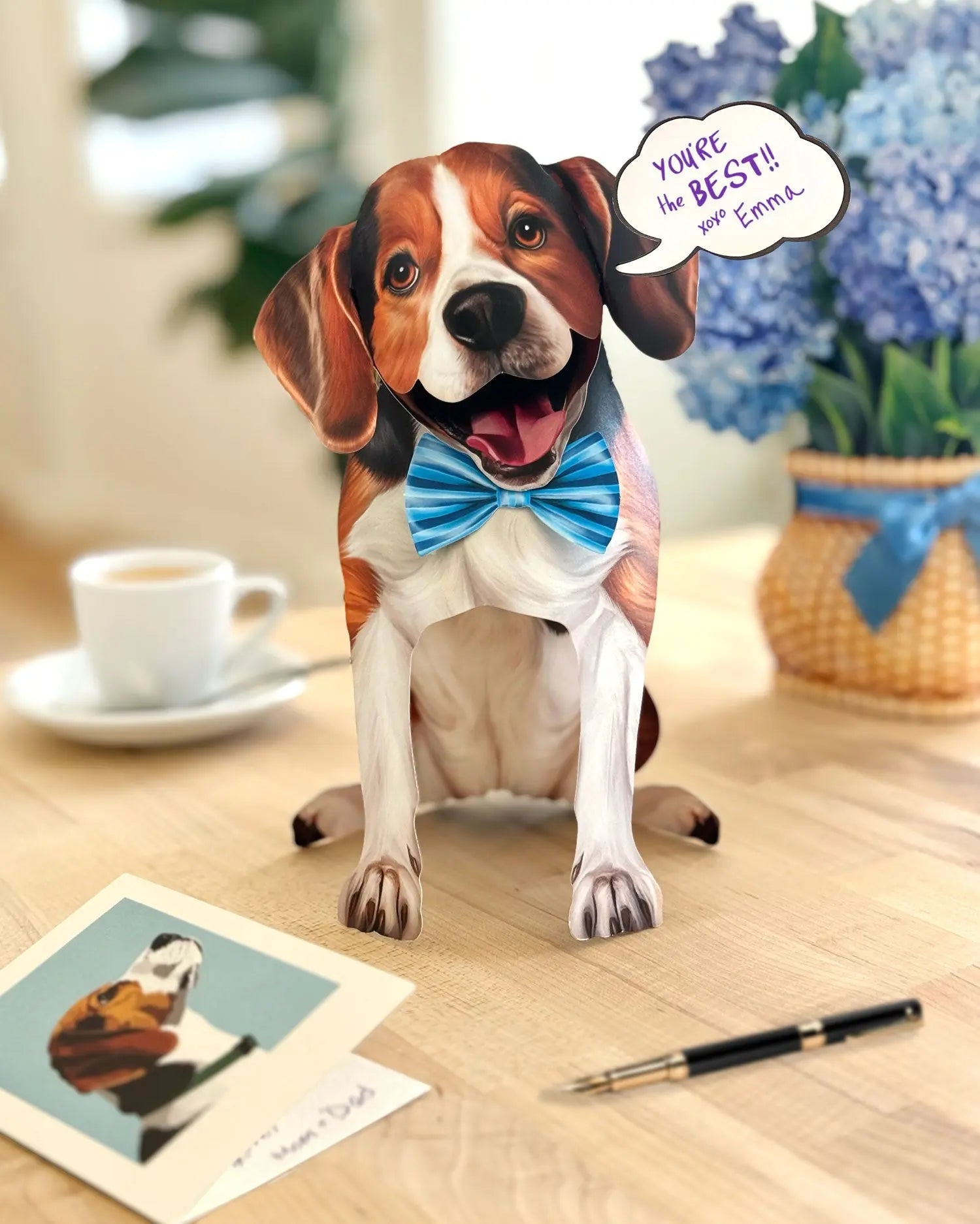 FreshCut Paper pop-up Beagle card with a speech bubble on a table with a cup and card.