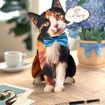 FreshCut paper calico cat pop-up card on a desk with a cup and flowers in the background.