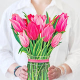 woman holding pink tulip bouquet
