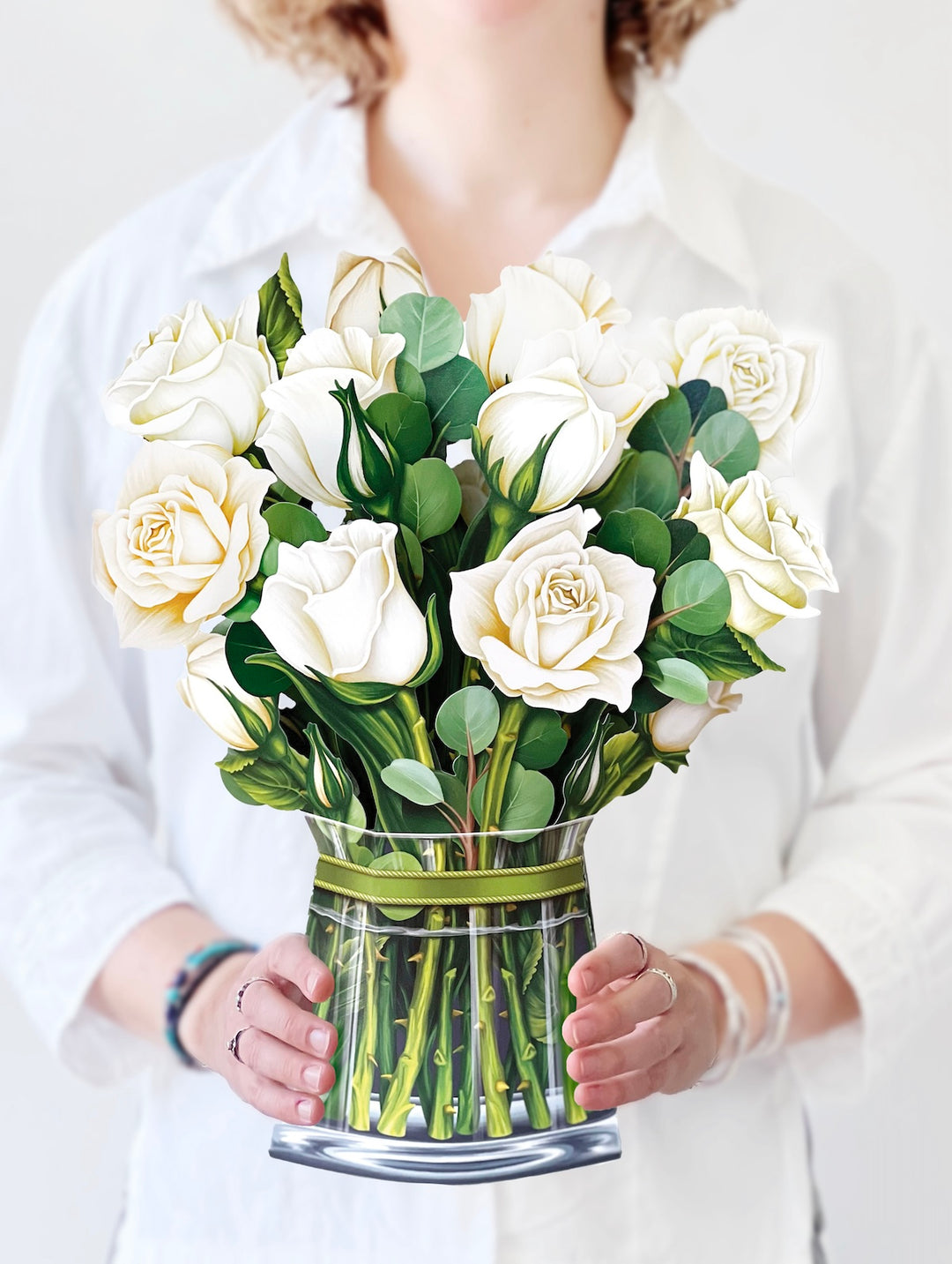 woman holding white roses bouquet