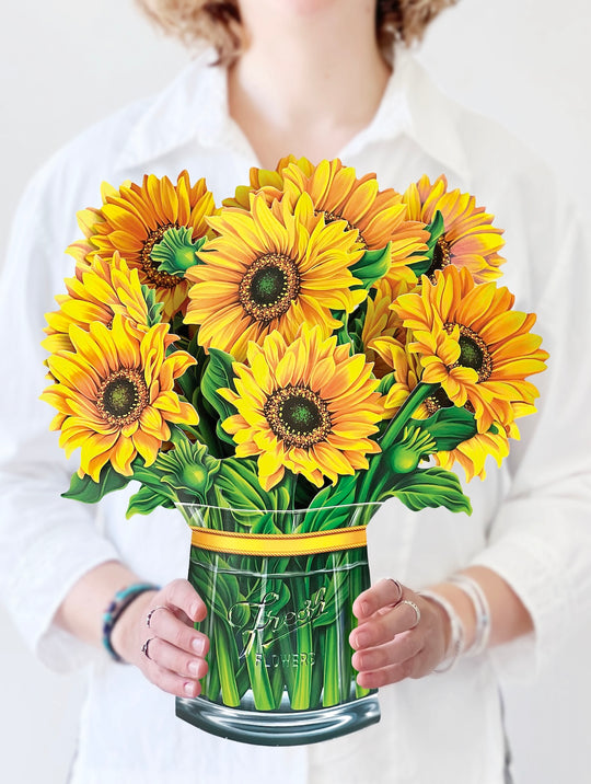 woman holding sunflower bouquet