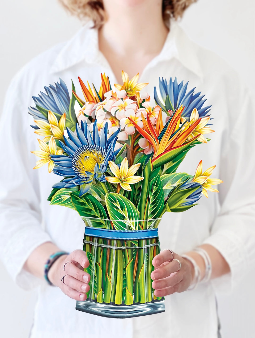 woman holding tropical bloom bouquet