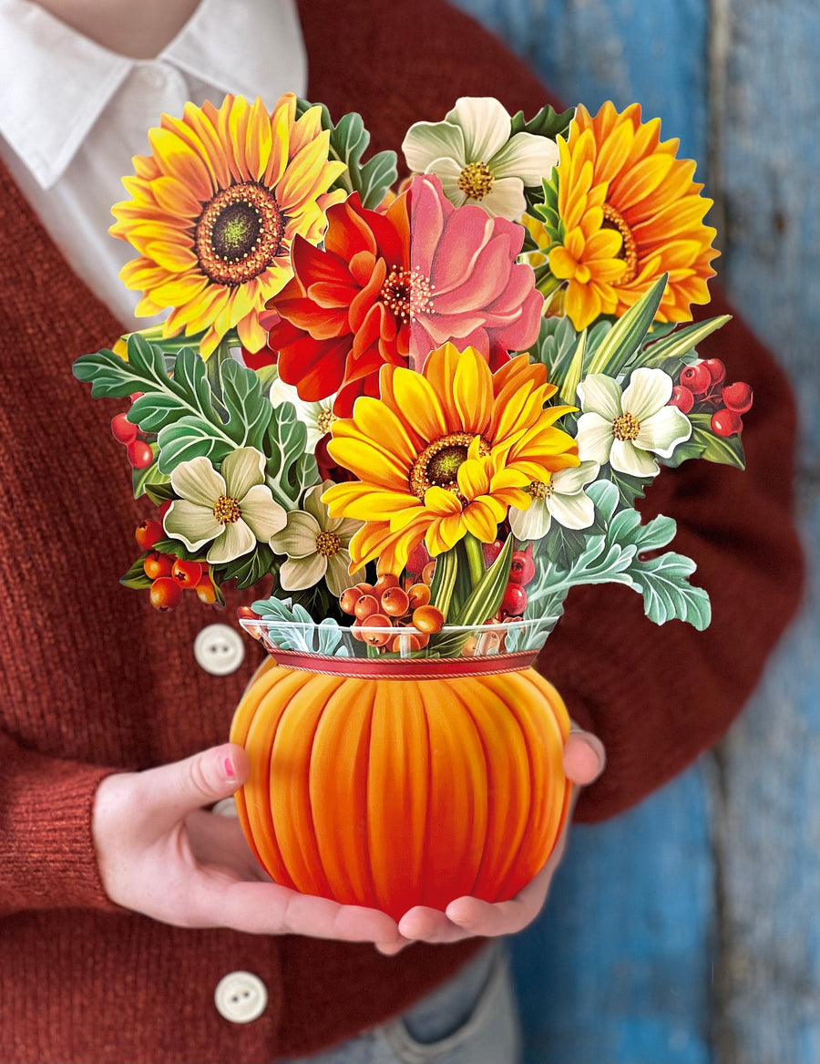 pumpkin harvest - a fall floral arrangement in a small paper pumpkin vase