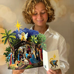 Woman holding popup paper nativity 