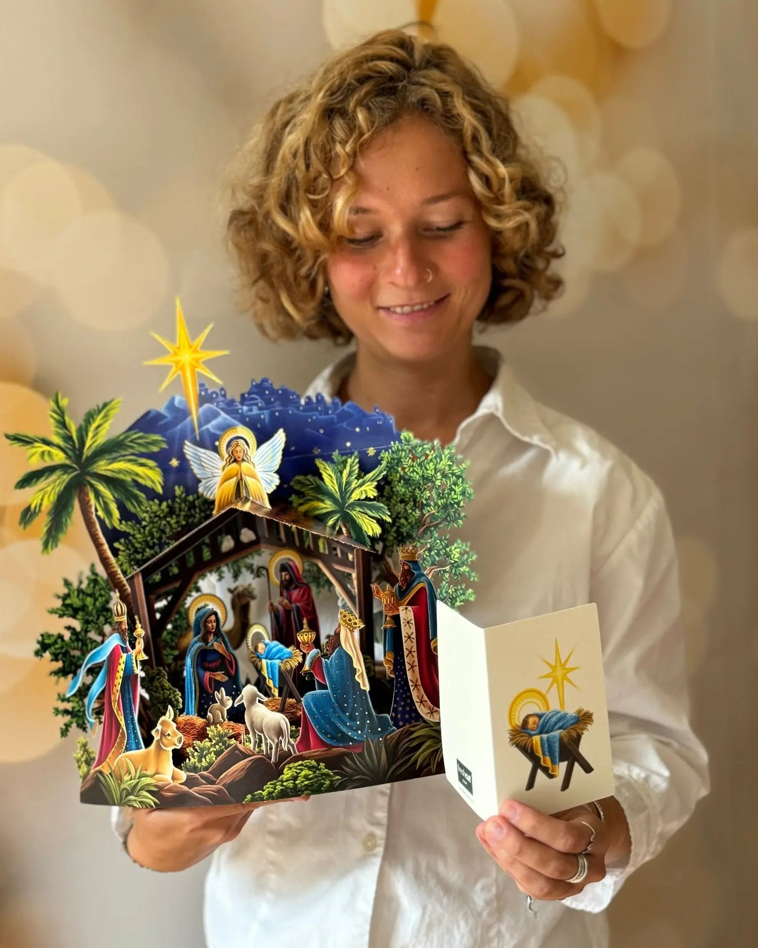 Woman holding popup paper nativity 