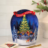 Decorative Christmas card with a snowy scene and animated figures, featuring a pen and card on a white surface.