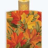 A pack of Freshcut paper sheets featuring an autumn leaf pattern with red, orange, yellow, and green leaves, berries, and a lit candle illustration at the top, shown on a light gray background.