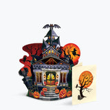 Halloween-themed pop-up card with a haunted house design on a light grey background