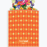 An orange Halloween-themed branded envelope with a diamond pattern and a colorful pop-up 'Happy Halloween!' floral and ghost design at the top, shown on a light gray background.