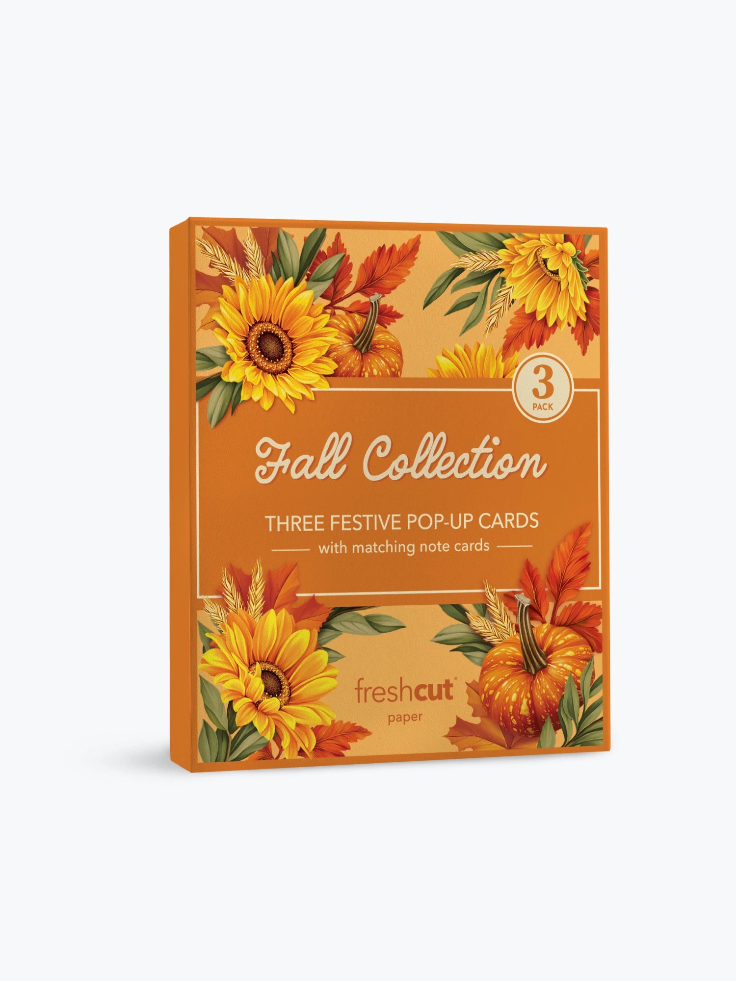 A boxed card set of 3 titled 'Fall Collection' with autumn-themed illustrations of sunflowers, pumpkins, leaves, and wheat on an orange background. The front text reads 'Three Festive Pop-Up Cards with matching note cards' and shows the FreshCut Paper brand logo