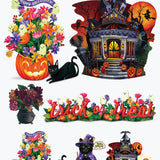 A set of Halloween-themed decorative cutouts and stickers on a plain white background, including a jack-o'-lantern flower arrangement with a black cat, a haunted house with bats and witch silhouette, a floral garland, a 'trick or treat' banner, a cauldron of dark flowers, a small witch figure, and another haunted house cutout.