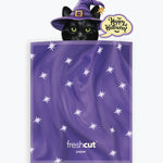 A purple Halloween-themed envelope with white star patterns, featuring a cartoon black cat in a purple witch hat peeking out above the top edge, with a 'Happy Halloween' speech bubble. The brand name 'freshcut paper' is printed near the bottom.