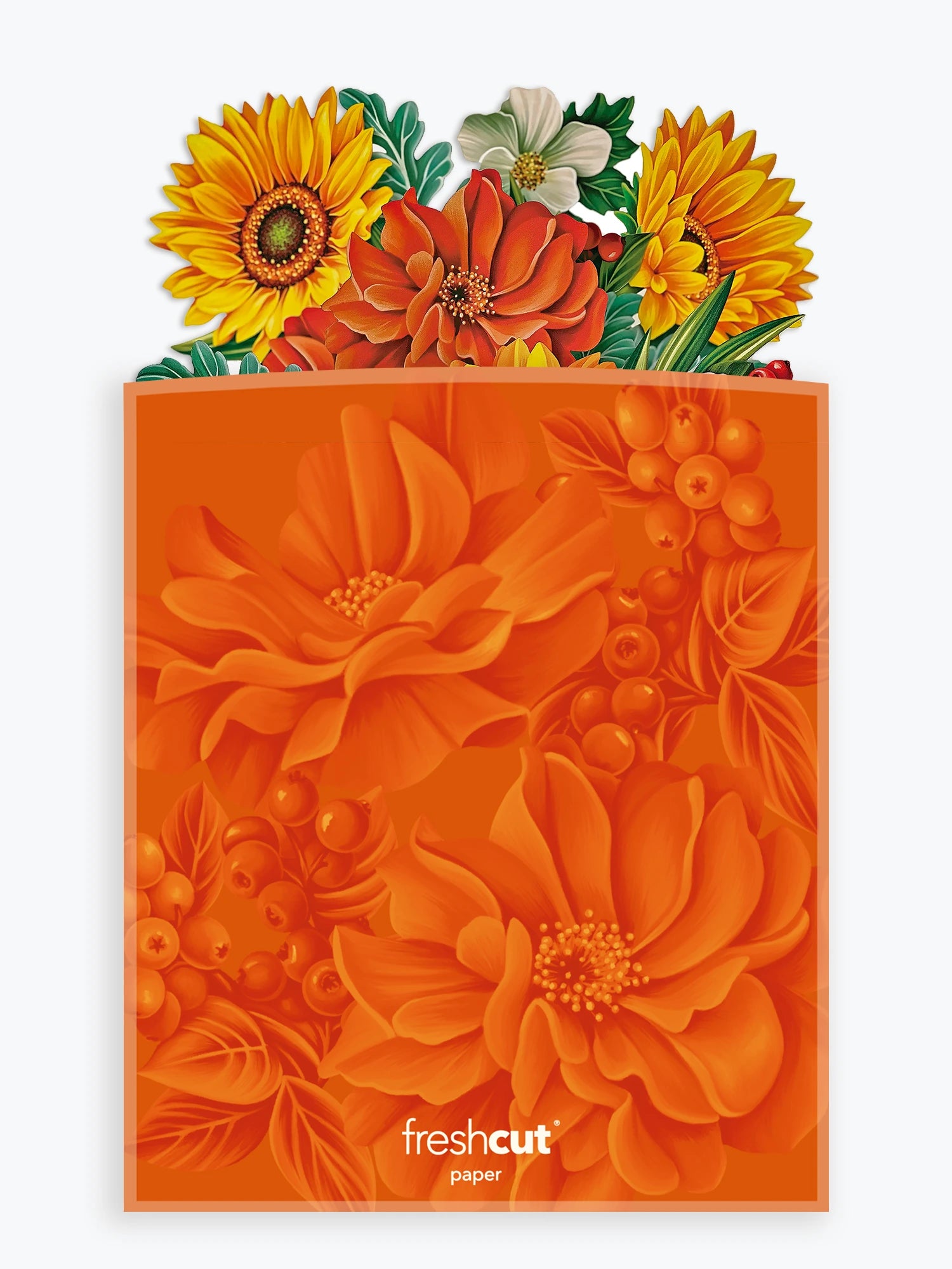 An orange floral envelope with a pop up bouquet coming out of the top with layered orange flowers, yellow sunflowers, and green leaves, shown on a light gray background. The brand name 'freshcut paper' is printed near the bottom.