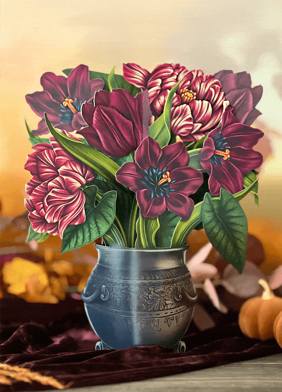 Decorating the Moonlight Garden pop-up bouquet by placing the included black raven and tiger moth accessories onto the arrangement.