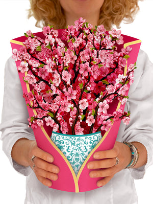 FreshCut Paper "Cherry Blossom" measure 12'' tall by 9" wide. Our stunning life sized, 3D pop up flowers include paper vase, matching note card and festive mailing envelope.