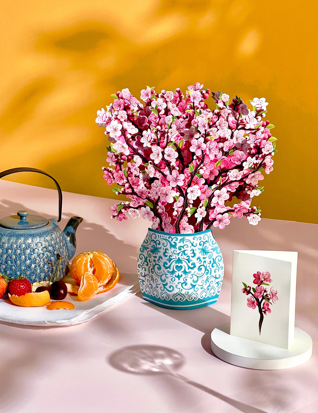 Our FreshCut Paper Cherry Blossom come ready to present in their own festive blue and white patterned vase. More than a greeting card, our flowers are always FreshCut Paper that never wilt, fade or require water.